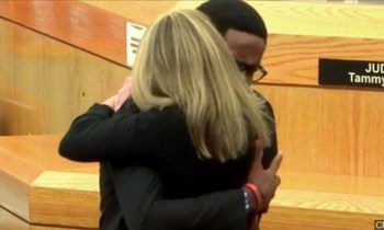 Brother of man killed by Dallas cop gets award for hugging her