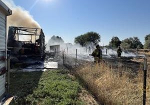 Travel trailer fire burns half acre in Finley