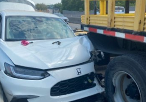 Driver hospitalized after car vs. construction truck crash on Blue Bridge