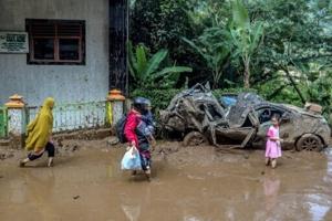 Indonesia digs out as flooding, landslide death toll hits 20